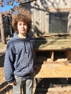 Ben Stephens next to Sweet Woodland Farm’s nesting boxes. LISA DAFFY