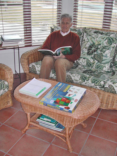 A few books beneath a table provide easy access reading in the sunroom of Larry Kuznick's Water Mill home. BRANDI BUCHMAN