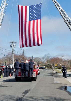 The funeral procession for Westhampton Beach Fire Department member Don Griffin passes by the firehouse on Saturday morning. COURTESY WESTHAMPTON BEACH FIRE DEPARTMENT