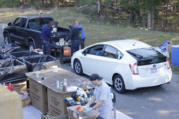 Cars are unloaded of their hazardous waste by Southampton Town waste management personnel. VALERIE GORDON