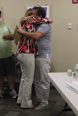 Westhampton Beach Trustees Hank Tucker and Patricia DiBenedetto hug in celebration after hearing that they were reelected on Friday. BY CAROL MORAN