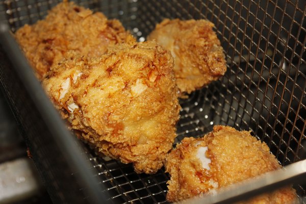 The fried chicken is ready to come out of the deep fryer. VALERIE GORDON