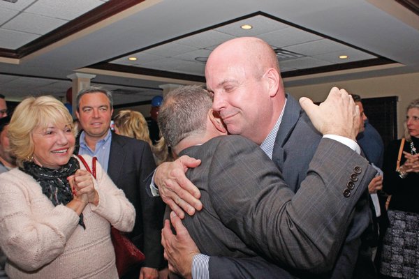 November 7: Stan Glinka, who finished the night as the top vote-getter for Southampton Town Board, receives a congratulatory hug at Villa Tuscano in East Quogue.