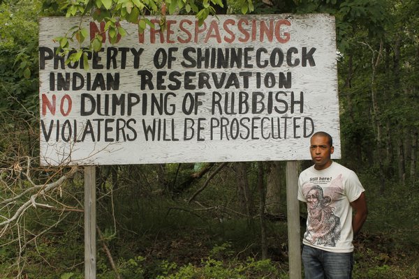 August 28 -- All sorts of litter can be found throughout the Shinnecock Indian Nation’s Westwoods lot. Shinnecock Trustee Bryan Polite at the property in Hampton Bays.