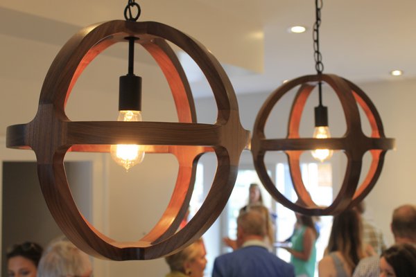 Two light fixtures hang above the kitchen of a Ponquogue Point condo that wa