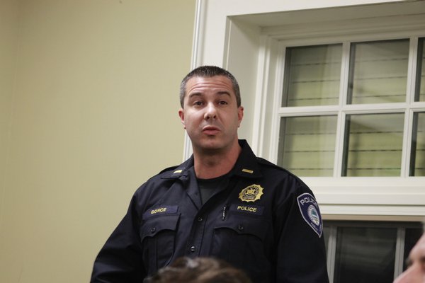 Westhampton Beach Village Police Lieutenant Trevor Gonce addresses a concerned citizen during the Village Board meeting last week. KYLE CAMPBELL