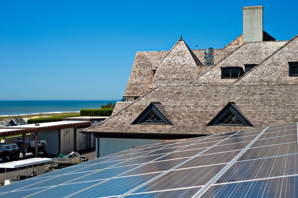 Solar panels on the Maidstone Club in East Hampton. New York State is trying to lower the cost of installation for communities. GREEN LOGIC