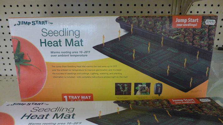 Inexpensive heating mats like this one are designed to go under standard-size flats and cell packs or other containers. The mat will maintain soil temperatures optimal for germination. ANDREW MESSINGER