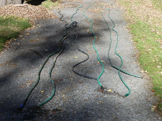 You may not want to store your hoses just yet but you can still get them ready. On a sunny, warm day they soften and are easy to drain on an incline, then coil and tie the coil. ANDREW MESSINGER