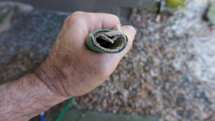 This Swan brand hose (not recommended) kept on kinking and even when un-kinked water flow was restricted. When cut open it was obvious that the inner plastic tube had crushed, cutting off the water supply. You can also see rubber and cord material as two of the plies. ANDREW MESSINGER