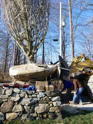 The beech is now freed from the truck but with power lines on one side and a stone wall on the other the work is done very slowly and meticulously. ANDREW MESSINGER