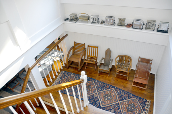 Collections of antique toasters and small chairs.