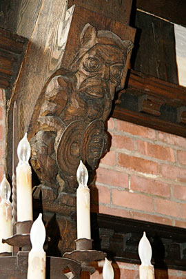 Gargoyles, each playing an instrument, decorate the massive beams.