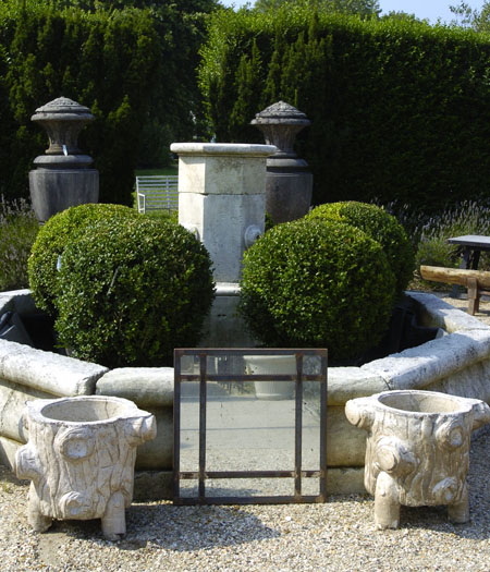 A raw angle iron eglomise mirror by Mary Gotovich in Mecox Gardens.