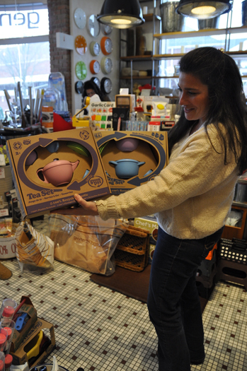 Sales associate Christine Milia points out eco-friendly tea and cookware sets for sale at General Home Store in East Hampton.