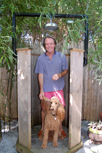 Ron Race and his dog, Sophie, in their outdoor shower in Water Mill.  Dawn Watson