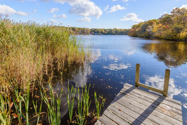 A four-bedroom, two-bathroom bungalow in Southampton also includes a dock on Big Fresh Pond. The owner is asking $799,000, though he is willing accept an equivalent Bitcoin offer. COURTESY AMADEUS EHRHARDT