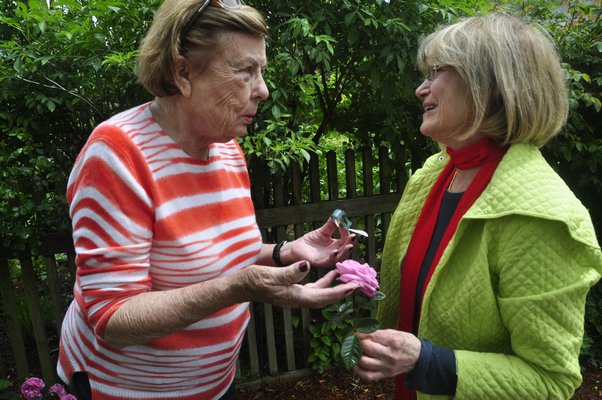 Helga Dawn, left, and Huguette Hersch talk roses. BY MICHELLE TRAURING