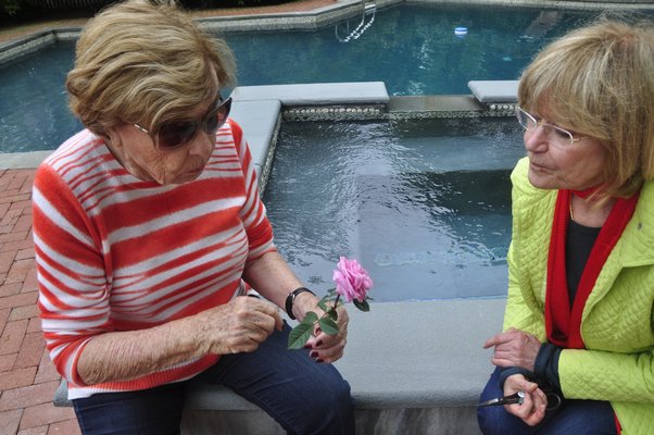 Helga Dawn, left, and Huguette Hersch talk roses. BY MICHELLE TRAURING