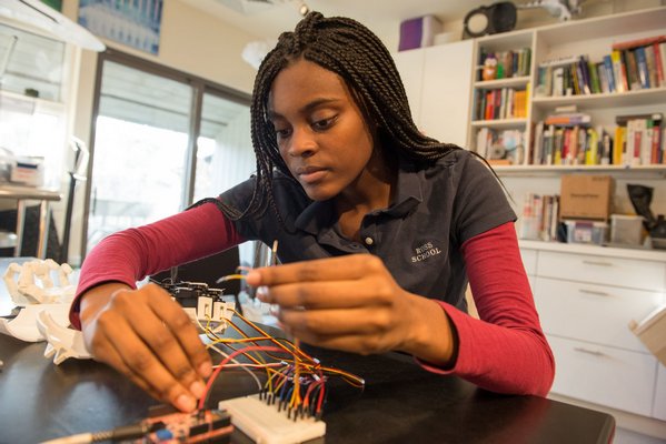 Elsa Diaw works with the 3-D printed, electrical prosthetic arm she created for her senior project at The Ross School. WIL WEISS