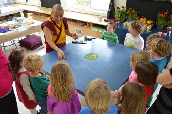 Lama Tenzin demonstrates how to create a mandala with sand. SHANNON TIMONEY