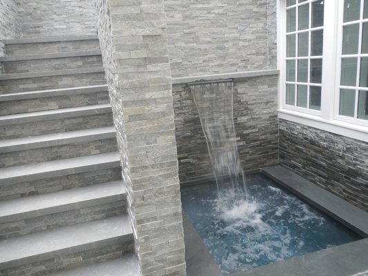 A second, more private, jacuzzi with a waterfall is accessible from the pool area via the stairs or from the finished basement. CAREY LONDON