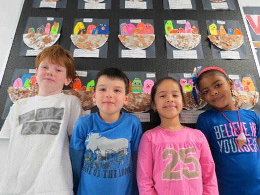 Sag Harbor Elementary School celebrated spring with a variety of projects recently.  First-graders, left to right, Nate Culver, Spencer Wellington-Amantia, Rashel Pacheco a