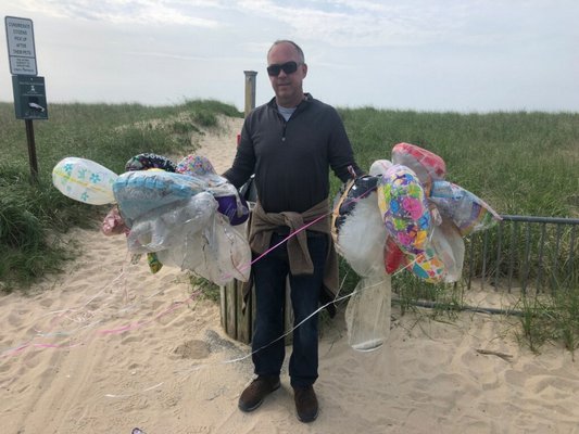 Tim Garneau shows off balloons he found on a walk between Atlantic Avenue Beach and Two Mile Hollow in East Hampton.  COURTESY COLLEEN HENN