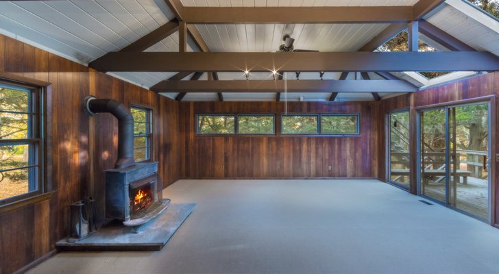 The main space in the tree house comes with a wood burning stove. COURTESY BROWN HARRIS STEVENS