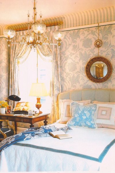 A combination of floral print and stripes add interest to the walls in this bedroom.   COURTESY  MARSHALL WATSON