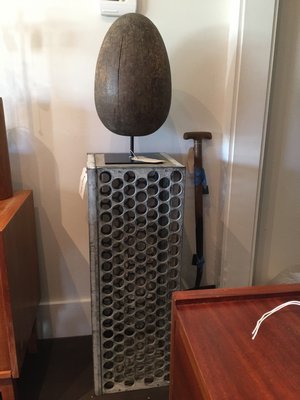 Robert Stilin's wooden egg mold paired with a pedestal of industrial egg crates. MARSHALL WATSON