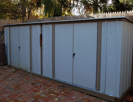 Storage units outside of the workshop store paints and combustibles.