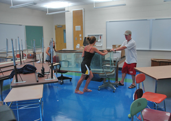 John Ryan, Jr. sets-up his new fifth grade classroom at John Marshall Elementary School with his daughters Shannon and Marikate.