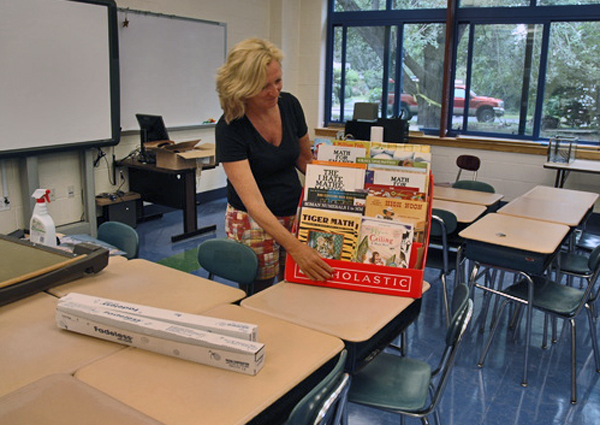 Linda Cameron, who has taught fifth grade for 21 years, sets up her new classroom at John Marshall Elementary School.