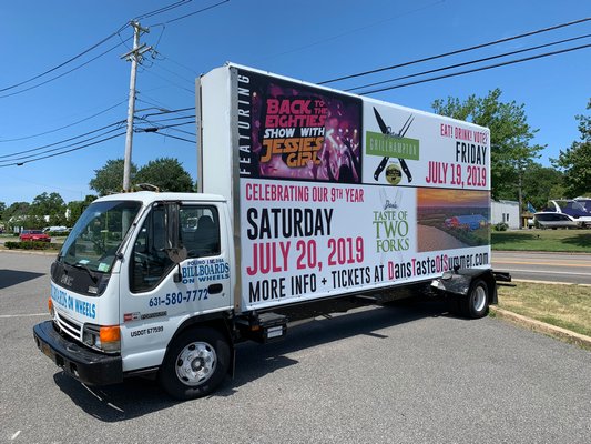 An advertisement for a Dan's Papers event sits propped on the back of a truck at the intersection of County Road 39 and Tuckahoe Lane. BEN KAVA