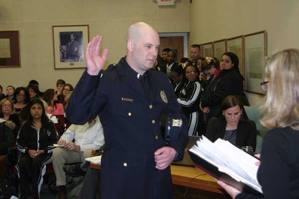Newly hired and newly promoted police officers were sworn in at Town Hall on Tuesday night. M. Wright