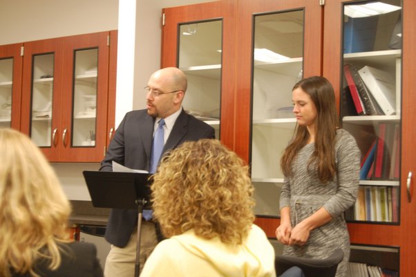 High School Principal Adam Fine introduces this year's saluditorian Maggie Pizzo to the school board at a meeting on March 18. Erica Thompson