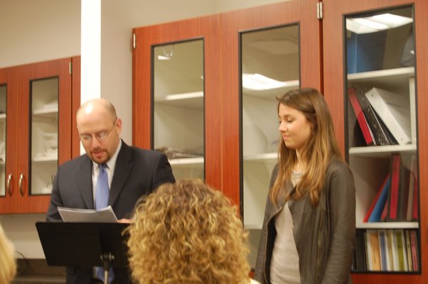 High School Principal Adam Fine introduces this year's valedictorian Carly Grossman to the school board at a meeting on March 18. Erica Thompson