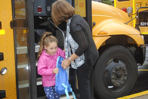 A student gets off the bus and heads in to East Quogue Elementary School on her first day. AMANDA BERNOCCO
