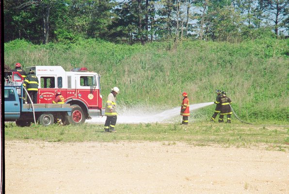 Firefighters spraying fire retardant foam during a disaster response exercise at the Wainscott gravel pit in June 2000.     MICHAEL WRIGHT