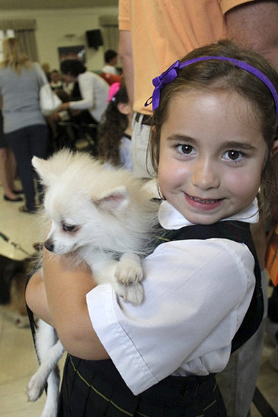 OLH first grade student Gabrielle Fenelon  of Hampton Bays with her dog at the blessing of the animals.