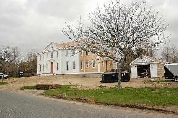A new house under construction on Glover Street near Sag Harbor Cove, elevated above grade to meet FEMA requirements. Notice the berm going up to the front door. ANNE SURCHIN