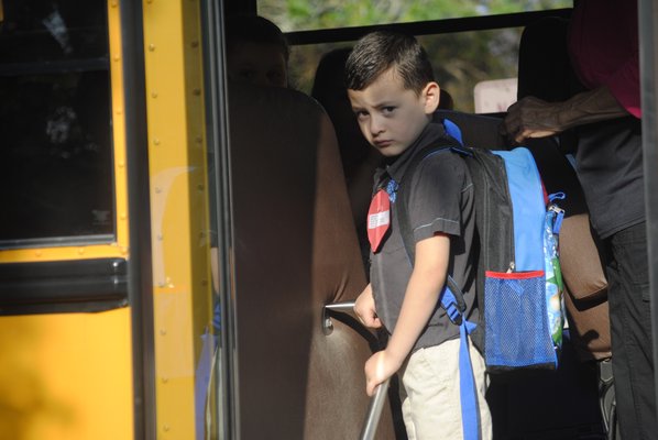 Jayden Castro Herrera, a kindergartener at Hampton Bays Elementary, gets off the bus for his first day of school on Tuesday morning. AMANDA BERNOCCO