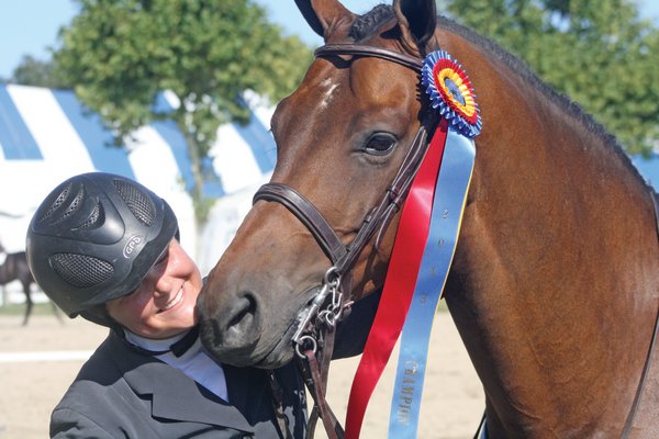 August 29: Claire Stevenson has been riding in the Hampton Classic since she was 8 years old, but she grabbed the coveted blue, red and yellow tri-color ribbon for the first time when she piloted Worthy to the championship in the local hunter non-pro division on opening day.
