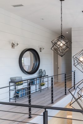 The upstairs walkway overlooks the foyer and leads to the guest bedrooms at Kristen Farrell's Home Show at 50 Lawrence Court in Water Mill. LENA YAREMENKO