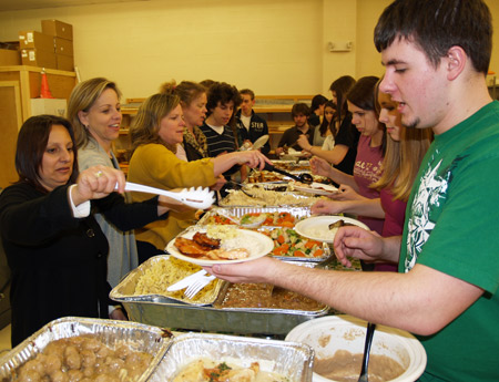 Eastport South Manor moms, left to right, Connie Sergio, Sue Tavella, Katie Spellman and Barbara Stanco serve home cooked meals to hungry cast and crew members during a rehearsal of “Les Miserables."