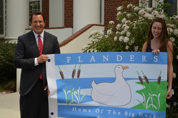 Southampton Town Councilman Chris Nuzzi and Shannon Merker, who designed the official flag for the hamlet of Flanders. BY KRISTEN DOULOS