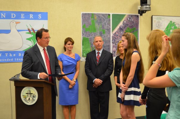Southampton Town Councilman Chris Nuzzi and Shannon Merker, who designed the official flag for the hamlet of Flanders. BY KRISTEN DOULOS