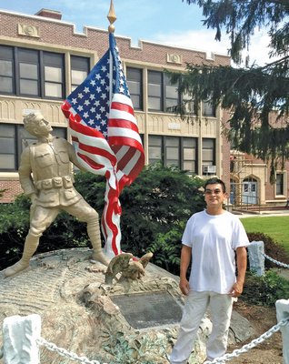 August 22: Fredy Cardona, who is employed by Capobianco Construction in Patchogue, has been working to restore the soldiers’ memorial that sits outside the Eastport Elementary School.
