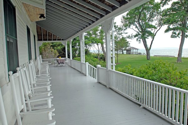 The huge wrap-around back porch offers dramatic views of the bay.  DANA SHAW